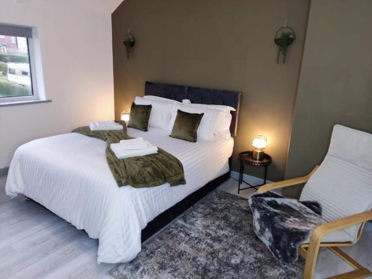 Main bedroom with double bed, ample storage, and cozy bedding